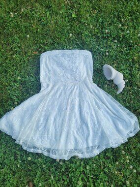 Adorable strapless white lace dress in a flattering fit and flare style.